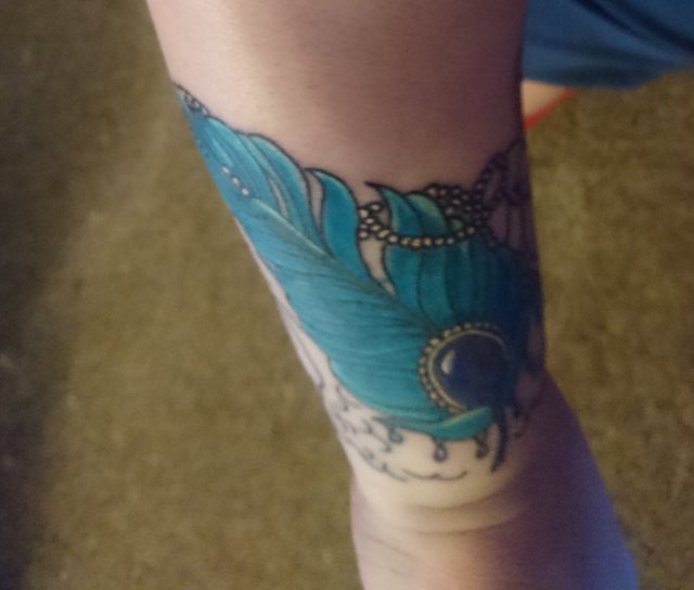 tattoo, lily-tattoo, floral-tattoo, tattoo-flowers, tattoo-coverup, cover-up, tattoo-by-thor, thor-gratts, mad-tatters, perfume-bottle, vintage-style-tattoo, peacock-feather, quarter-sleeve, wrist-tattoo, flowers-bottle-feather-tattoo