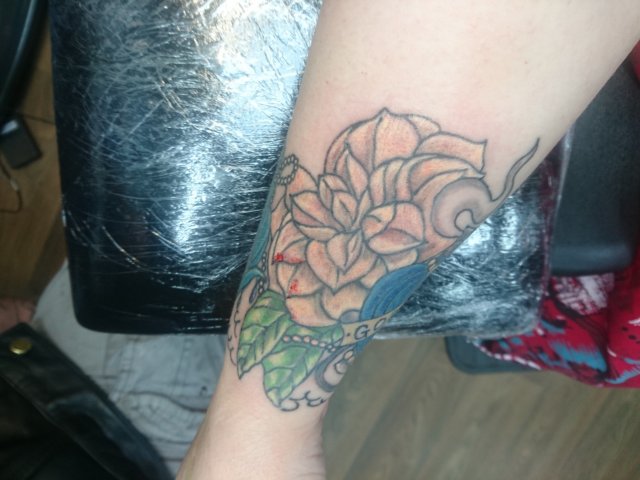 tattoo, lily-tattoo, floral-tattoo, tattoo-flowers, tattoo-coverup, cover-up, tattoo-by-thor, thor-gratts, mad-tatters, perfume-bottle, vintage-style-tattoo, peacock-feather, quarter-sleeve, wrist-tattoo, flowers-bottle-feather-tattoo, camellia, hibiscus, wrist-cuff